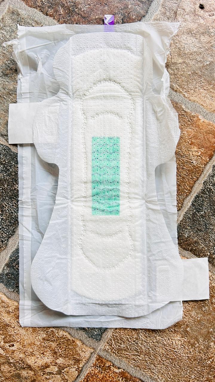 An unwrapped FRNDS24 XL+ pad, showing the green anion strip down the centre